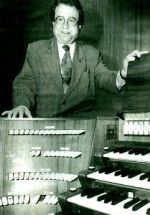 Karl-Heinz Obernier am Orgeltisch stehend.